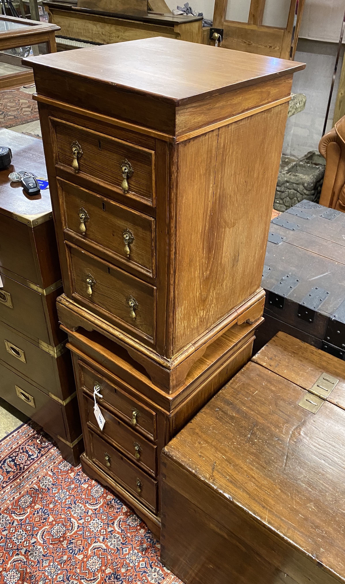 A pair of stained pine three drawer square bedside chests, width 39cm, height 66cm